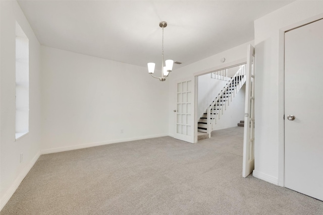 129 Western Ave, Saginaw, TX 76179 - empty room featuring carpet, stairs, a chandelier, and baseboards
