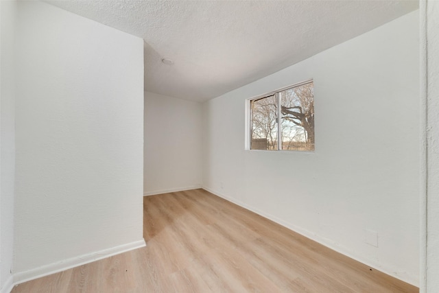 129 Western Ave, Saginaw, TX 76179 - unfurnished room featuring light wood finished floors, baseboards, and a textured ceiling