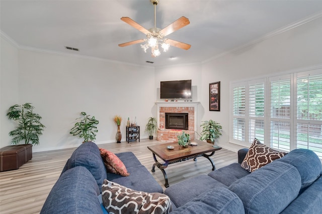 6729 Lucas Ln, North Richland Hills, TX 76182 - living room with wood finished floors, baseboards, ornamental molding, a brick fireplace, and ceiling fan
