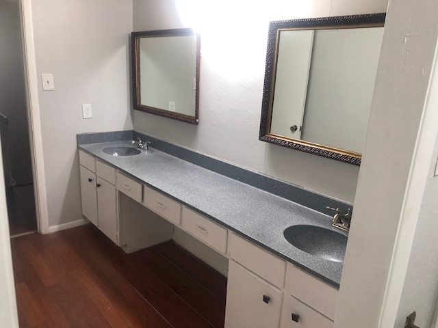 2149 Fleur De Lis Ct Unit 4, Arlington, TX 76012 - bathroom featuring wood finished floors, double vanity, and baseboards