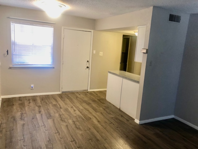 2149 Fleur De Lis Ct Unit 4, Arlington, TX 76012 - spare room featuring wood finished floors, baseboards, and a textured ceiling