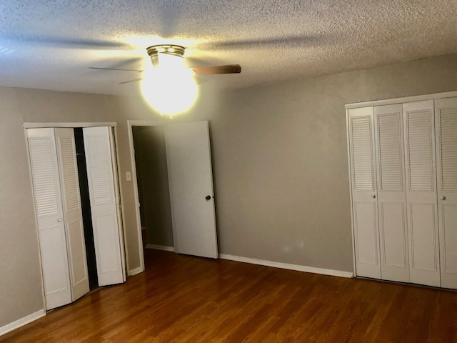2149 Fleur De Lis Ct Unit 4, Arlington, TX 76012 - unfurnished bedroom with wood finished floors, two closets, a textured ceiling, ceiling fan, and baseboards