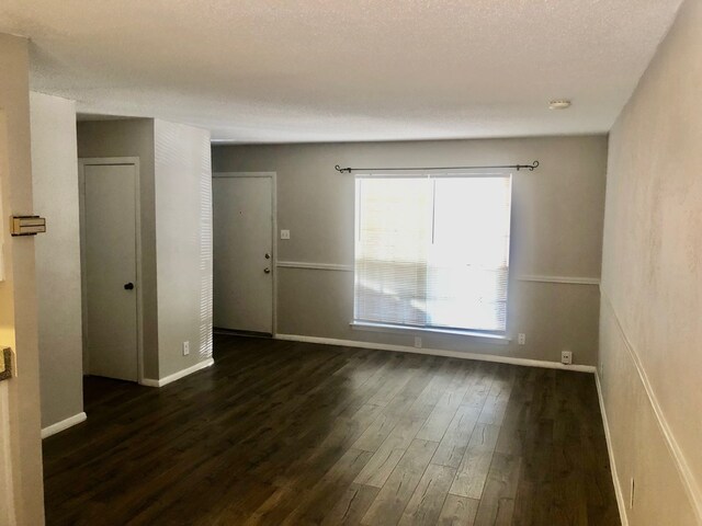 2149 Fleur De Lis Ct Unit 4, Arlington, TX 76012 - bathroom featuring double vanity, toilet, a textured ceiling, wood finished floors, and a shower