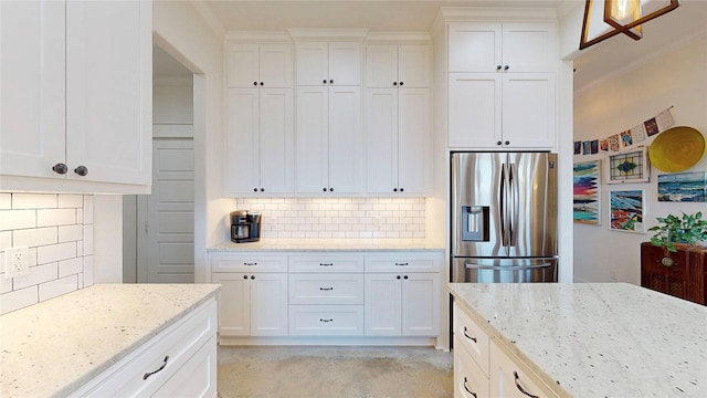 18358 Timber Oaks Dr, Lindale, TX 75771 - kitchen with stainless steel fridge with ice dispenser, decorative backsplash, white cabinets, light stone countertops, and ornamental molding