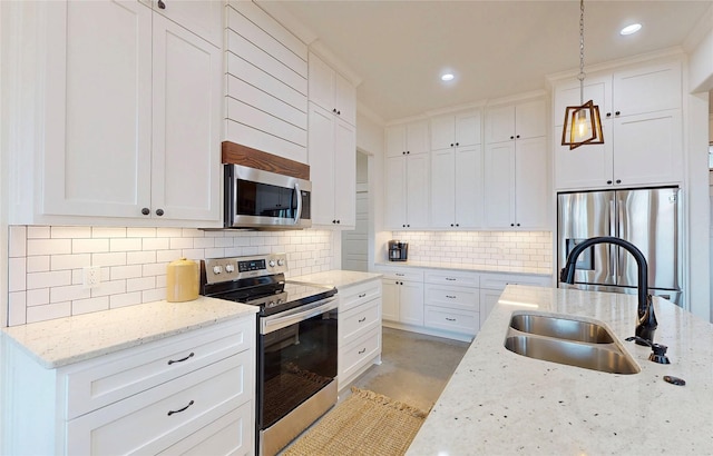 18358 Timber Oaks Dr, Lindale, TX 75771 - kitchen featuring stainless steel appliances, a sink, tasteful backsplash, decorative light fixtures, and finished concrete flooring