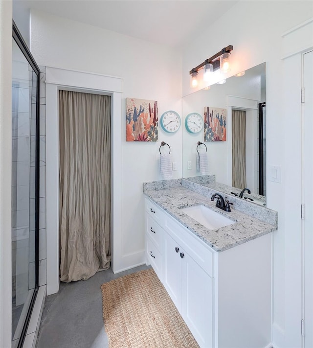 18358 Timber Oaks Dr, Lindale, TX 75771 - full bathroom featuring concrete flooring, vanity, a shower with shower door, and baseboards