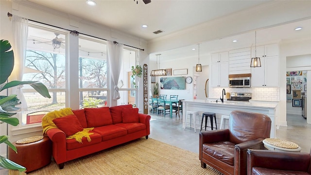 18358 Timber Oaks Dr, Lindale, TX 75771 - living area with concrete floors, a ceiling fan, recessed lighting, and crown molding