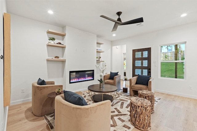 2508 Kool Ave, Dallas, TX 75241 - living area featuring light wood finished floors, a glass covered fireplace, a ceiling fan, recessed lighting, and baseboards