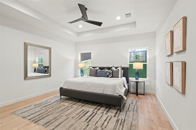 2508 Kool Ave, Dallas, TX 75241 - bedroom with a raised ceiling, light wood-style floors, baseboards, ceiling fan, and recessed lighting