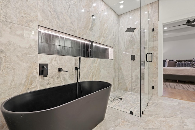 2508 Kool Ave, Dallas, TX 75241 - bathroom with connected bathroom, a shower stall, a soaking tub, tile walls, and recessed lighting