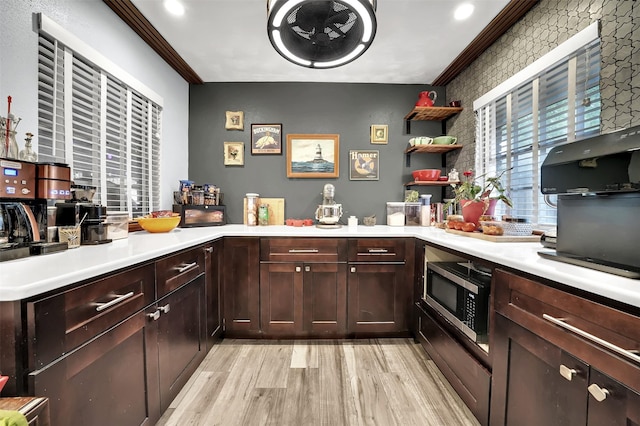1225 Oak Meadows Dr, Dallas, TX 75232 - kitchen with stainless steel microwave, light wood-style floors, light countertops, open shelves, and crown molding