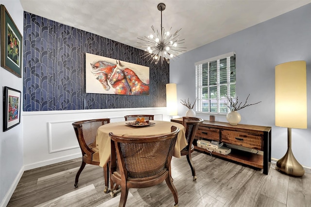 1225 Oak Meadows Dr, Dallas, TX 75232 - dining room with an accent wall, wood finished floors, a chandelier, baseboards, and wallpapered walls