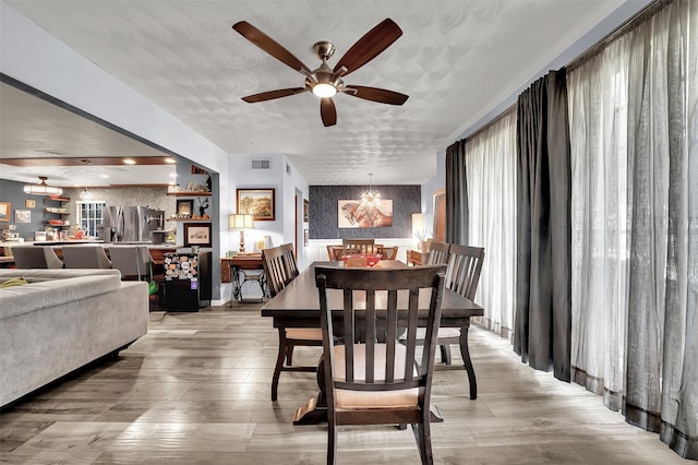 1225 Oak Meadows Dr, Dallas, TX 75232 - dining area with a ceiling fan, a chandelier, and wallpapered walls