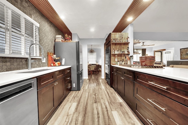 1225 Oak Meadows Dr, Dallas, TX 75232 - kitchen with appliances with stainless steel finishes, a sink, light wood-style floors, light countertops, and open shelves
