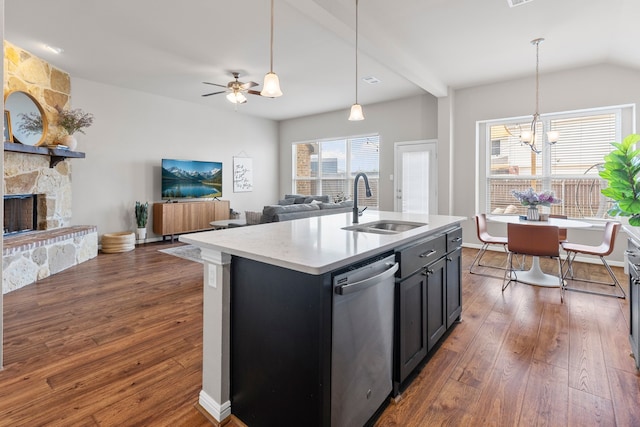 125 Singleton Dr, Royse City, TX 75189 - kitchen with a sink, stainless steel dishwasher, dark wood-style flooring, a fireplace, and open floor plan