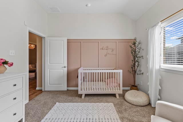 125 Singleton Dr, Royse City, TX 75189 - bedroom with carpet floors, a nursery area, lofted ceiling, a decorative wall, and a wainscoted wall