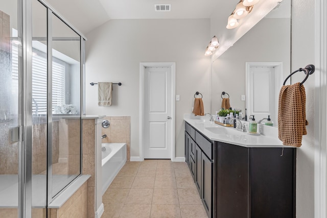 125 Singleton Dr, Royse City, TX 75189 - bathroom with tile patterned flooring, a garden tub, a shower stall, double vanity, and lofted ceiling