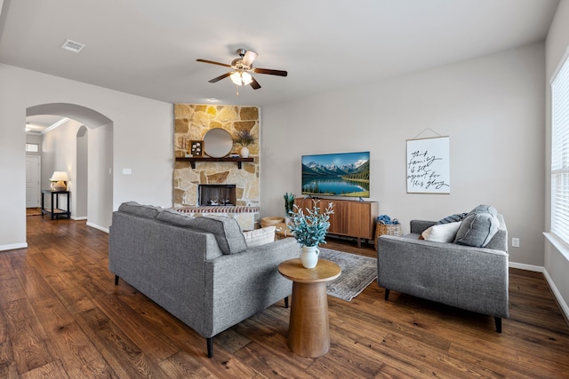 125 Singleton Dr, Royse City, TX 75189 - living room featuring a ceiling fan, arched walkways, dark wood-style floors, and baseboards