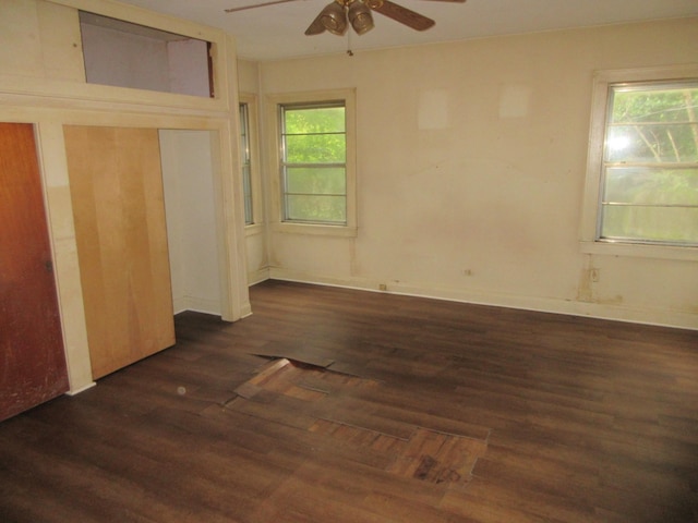 unfurnished bedroom featuring wood finished floors, a ceiling fan, and baseboards