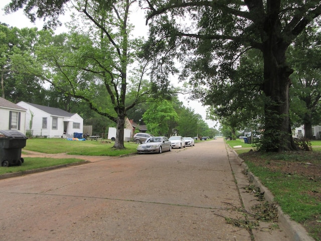 view of concrete street with curbs and a residential view
