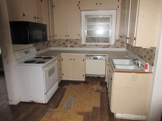 kitchen featuring white appliances, backsplash, a sink, light countertops, and white cabinetry