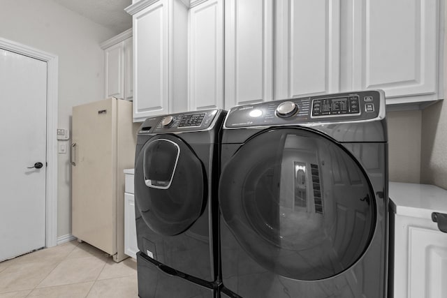 836 Stafford Station Dr, Saginaw, TX 76131 - washroom with washing machine and dryer, light tile patterned floors, and cabinet space