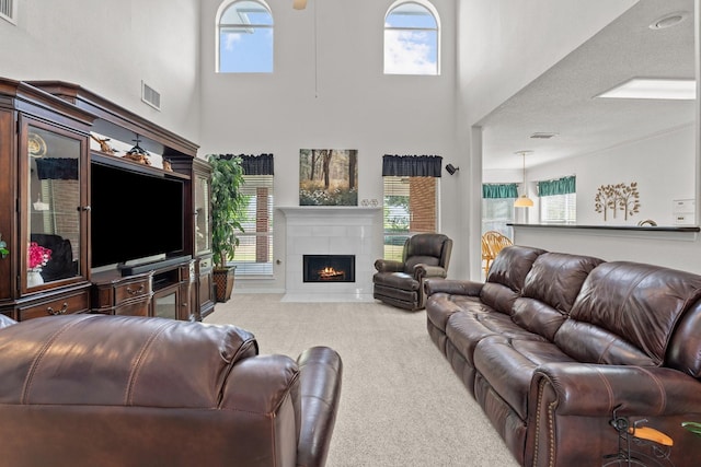 836 Stafford Station Dr, Saginaw, TX 76131 - living room with carpet floors, a towering ceiling, plenty of natural light, and a tile fireplace