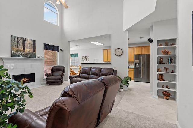 836 Stafford Station Dr, Saginaw, TX 76131 - living area with a towering ceiling, light carpet, light tile patterned floors, a tiled fireplace, and built in features