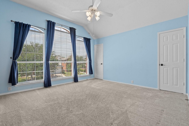 836 Stafford Station Dr, Saginaw, TX 76131 - carpeted empty room with a ceiling fan, vaulted ceiling, baseboards, and a textured ceiling