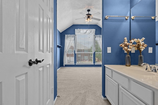 836 Stafford Station Dr, Saginaw, TX 76131 - bathroom with ceiling fan, vanity, lofted ceiling, a textured ceiling, and baseboards