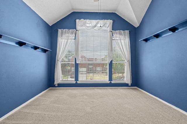 836 Stafford Station Dr, Saginaw, TX 76131 - empty room with lofted ceiling, carpet, a textured ceiling, a ceiling fan, and baseboards