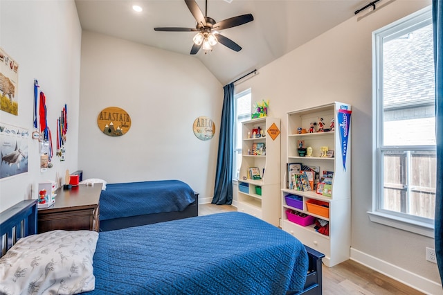 1305 Limestone Ridge Rd, Mansfield, TX 76063 - bedroom with light wood-type flooring, multiple windows, vaulted ceiling, baseboards, and a ceiling fan