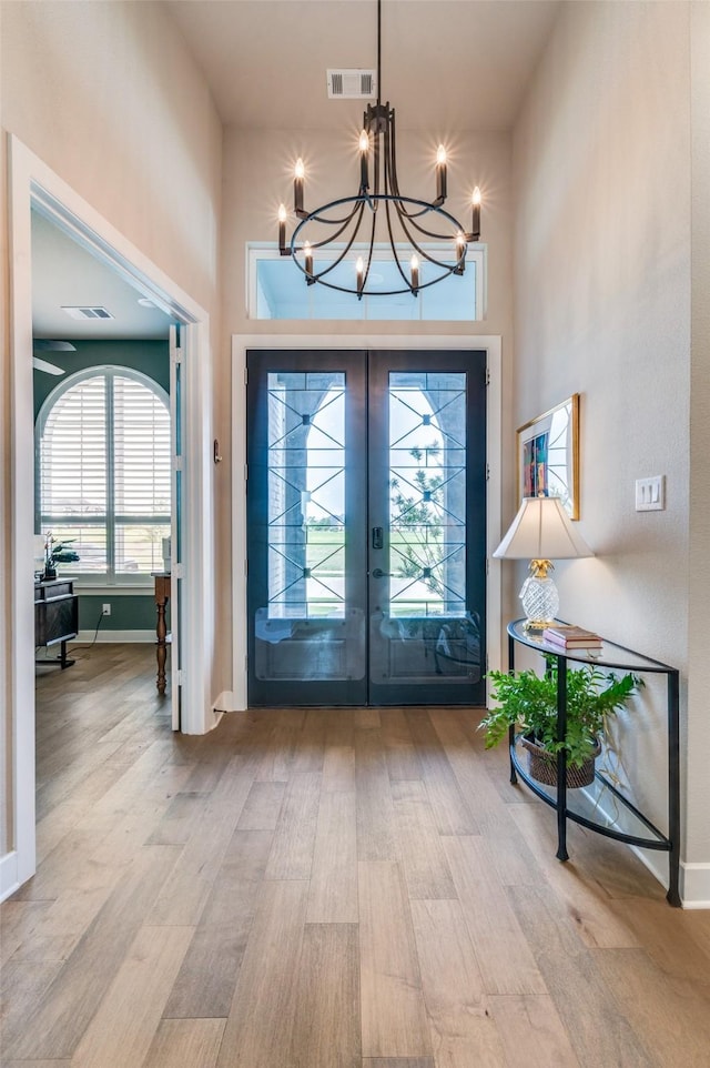 1305 Limestone Ridge Rd, Mansfield, TX 76063 - entrance foyer featuring wood finished floors, a chandelier, french doors, a high ceiling, and baseboards