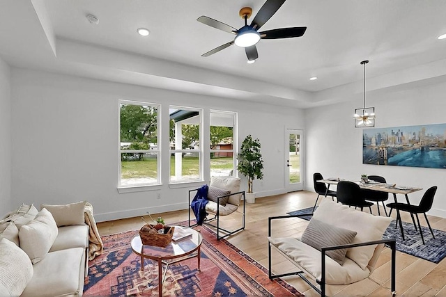 704 Witt, Wolfe City, TX 75496 - living room featuring a tray ceiling, baseboards, ceiling fan, recessed lighting, and light wood finished floors