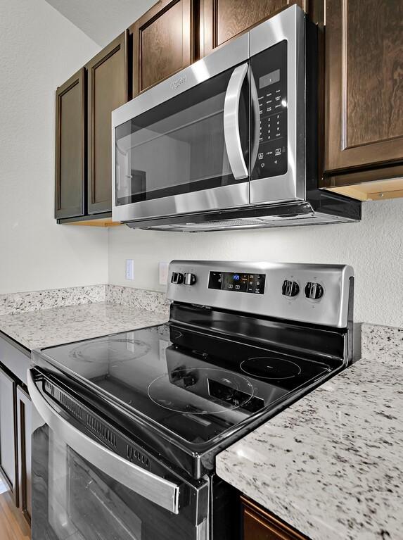 7025 Canadian Dr, Waco, TX 76633 - kitchen featuring stainless steel appliances and dark brown cabinets