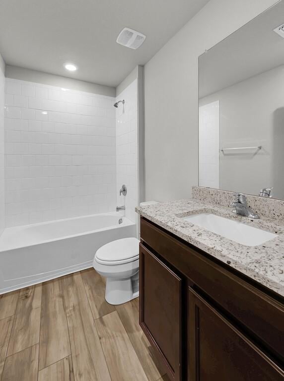 7025 Canadian Dr, Waco, TX 76633 - bathroom with toilet, wood finished floors, shower / tub combination, and vanity