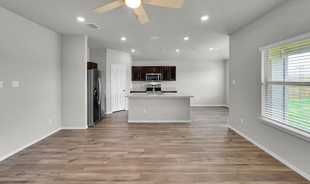 7025 Canadian Dr, Waco, TX 76633 - kitchen with stainless steel appliances, a ceiling fan, light wood-style floors, light countertops, and recessed lighting