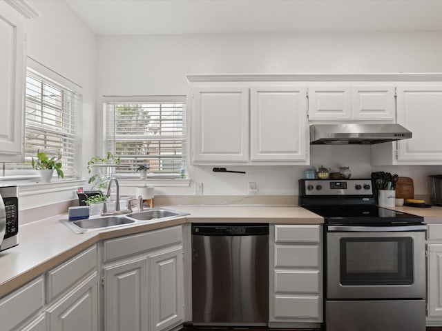2500 Peargrove Cir, Arlington, TX 76006 - kitchen with stainless steel appliances, under cabinet range hood, a sink, and white cabinetry