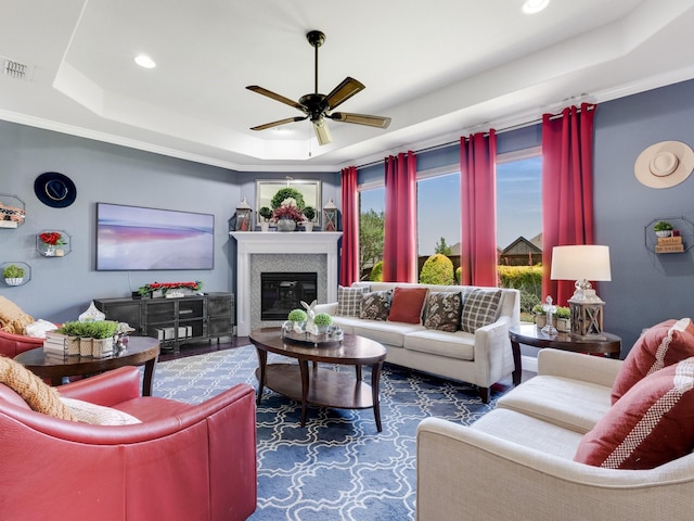 7428 E Fork Ln, Mckinney, TX 75071 - living area with a tray ceiling, ceiling fan, recessed lighting, and a glass covered fireplace
