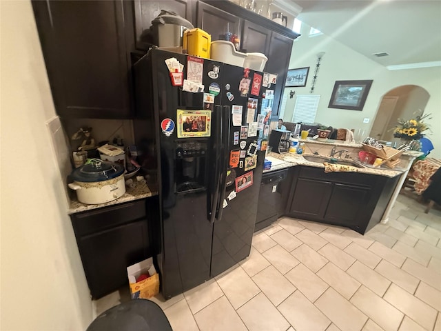 kitchen featuring black appliances, light tile patterned flooring, a peninsula, and a sink