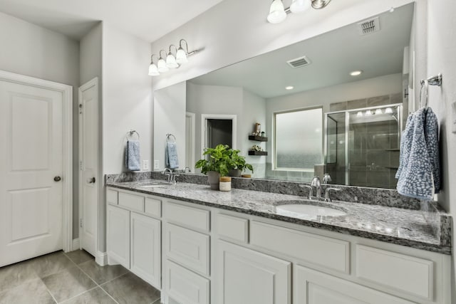 4138 Sanders Dr, Celina, TX 75009 - bathroom featuring a stall shower, tile patterned flooring, and double vanity