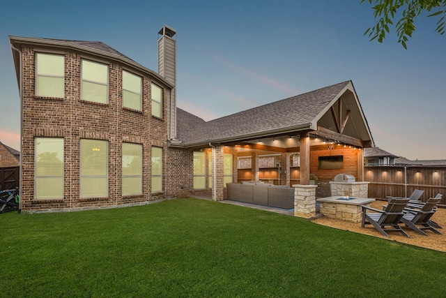 4138 Sanders Dr, Celina, TX 75009 - back of property at dusk featuring area for grilling, brick siding, roof with shingles, a chimney, and a patio area