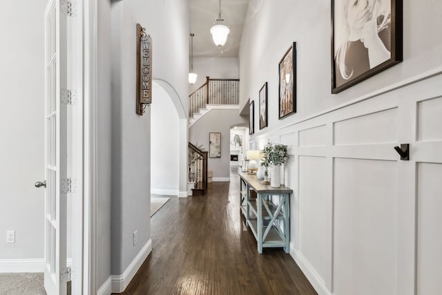 4138 Sanders Dr, Celina, TX 75009 - corridor with arched walkways, dark wood-type flooring, stairway, and a decorative wall