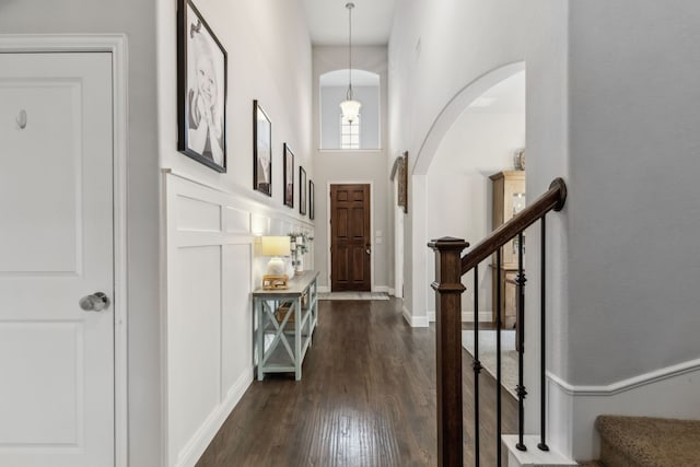 4138 Sanders Dr, Celina, TX 75009 - foyer entrance with dark wood-style flooring, a towering ceiling, stairs, and arched walkways
