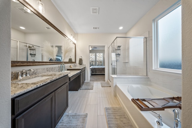 9517 Sunset Ln, Oak Point, TX 75068 - full bathroom featuring healthy amount of natural light, a shower stall, two vanities, and recessed lighting