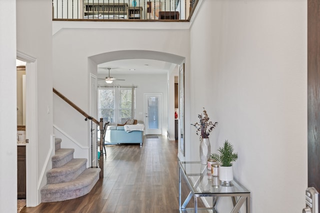 9517 Sunset Ln, Oak Point, TX 75068 - entrance foyer featuring a ceiling fan, arched walkways, wood finished floors, a towering ceiling, and stairway