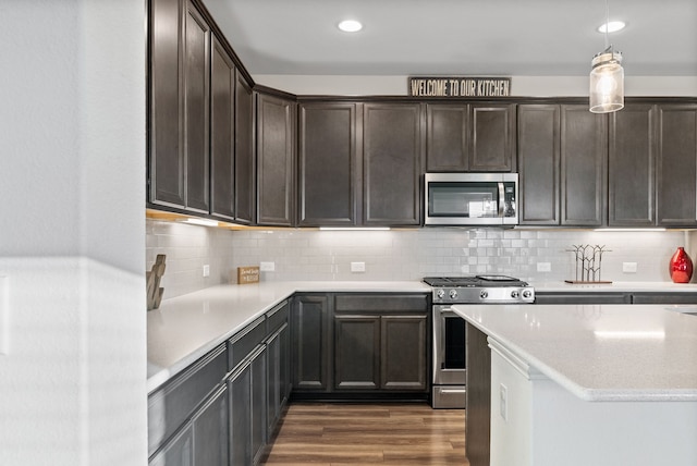 9517 Sunset Ln, Oak Point, TX 75068 - kitchen with appliances with stainless steel finishes, dark wood-style flooring, dark brown cabinetry, backsplash, and recessed lighting