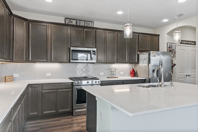 9517 Sunset Ln, Oak Point, TX 75068 - kitchen with appliances with stainless steel finishes, a sink, dark brown cabinets, recessed lighting, and dark wood-style flooring