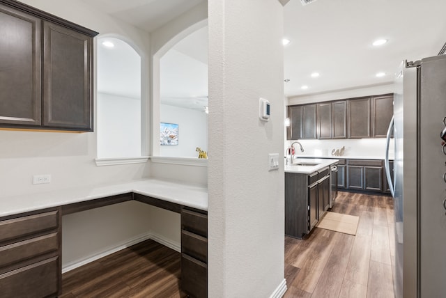 9517 Sunset Ln, Oak Point, TX 75068 - kitchen featuring stainless steel appliances, dark wood-type flooring, dark brown cabinets, a sink, and light countertops