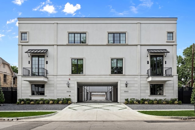 3943 Hawthorne Unit 102, Dallas, TX 75219 - view of front of house with a balcony, stucco siding, and driveway